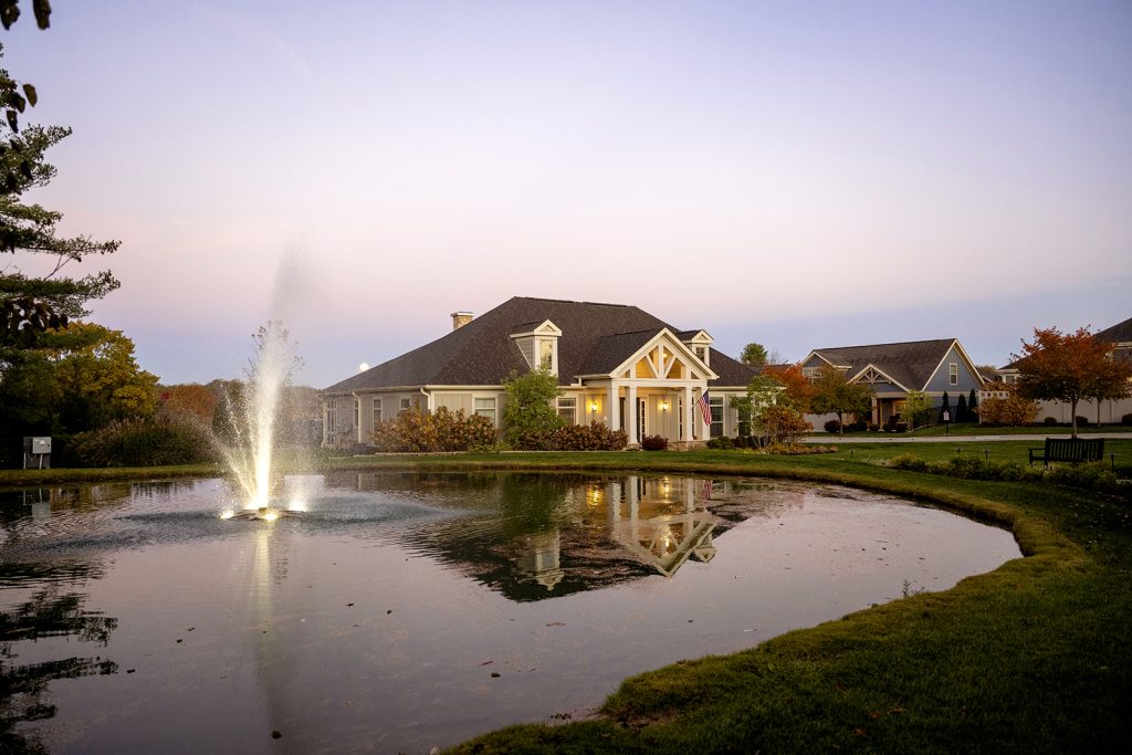 The clubhouse and pond with a fountain in early morning at The Courtyards on Riverside